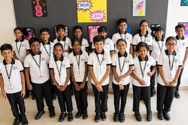 CBSE primary school students in grades 1 to 5 posing together inside the school campus.