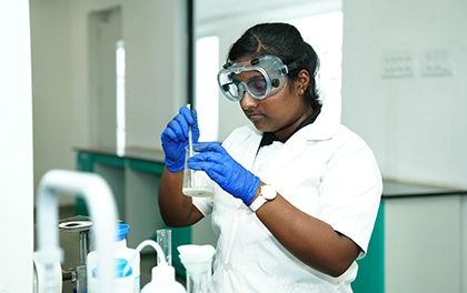 Higher secondary student conducting a science experiment for stream-based learning and preparation.   