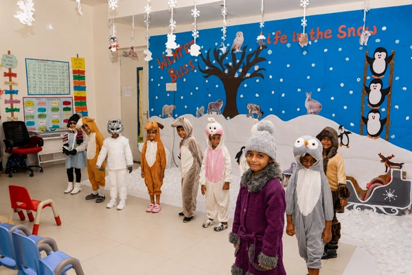 Children dressed in animal and winter costumes for early childhood learning at the kindergarten.