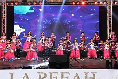 Cultural events for student learning and community engagement with children performing on stage.