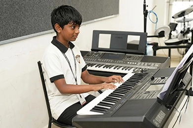 Dance and music activities for creative student development featuring a student playing piano.