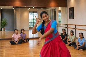 Students learning traditional dance movements from an instructor in a spacious studio.