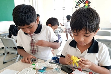 Robotics and STEM activities for primary school students in Vanagaram building models.