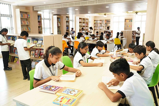 School library facilities for reading and research in Vanagaram with students reading books.