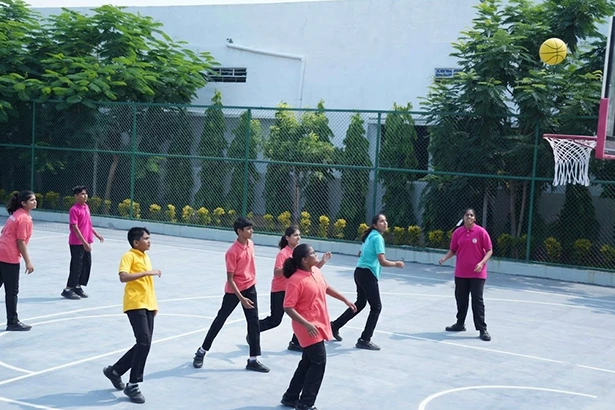 Sports and physical education facilities for student development with students playing basketball.