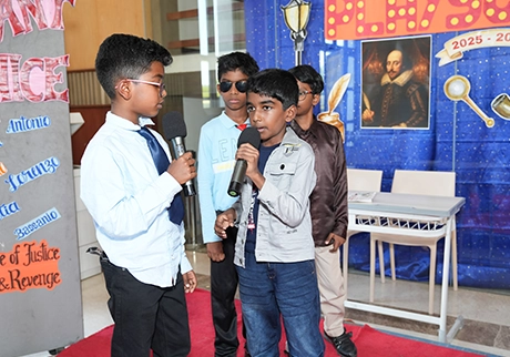 Students participating in a school event with a themed presentation and student performance