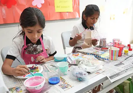 Students creating colorful artwork during a creative classroom art activity at school today