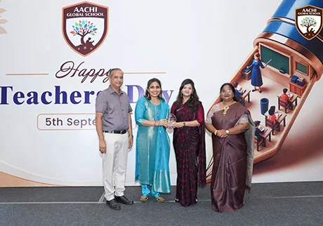 Teachers receiving annual awards during a school event celebrating professional achievements