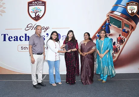 Teachers receiving awards during a school celebration for academic achievements and service