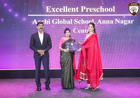 Educators presenting an excellent preschool award during a school recognition ceremony event