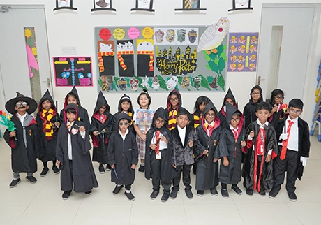 Students performing in themed costumes during a creative school event and cultural program