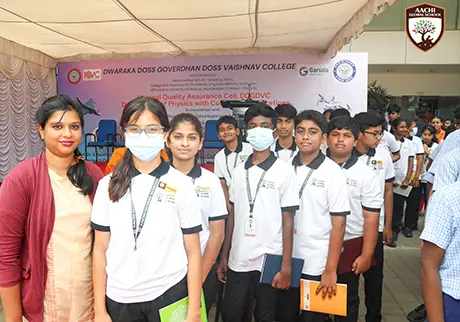 Students visiting a school exhibition event and exploring educational displays with teachers
