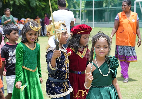 Students dressed in traditional costumes during a school cultural celebration event together